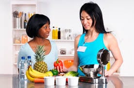 women looking at fruit