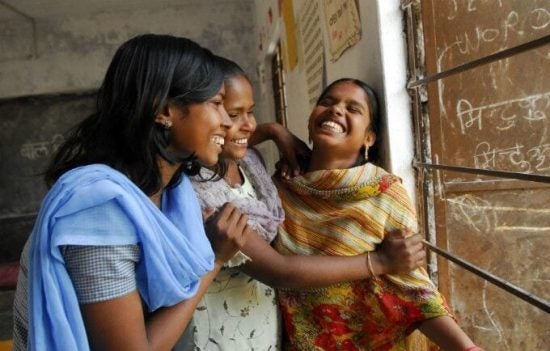 Three girls laughing together