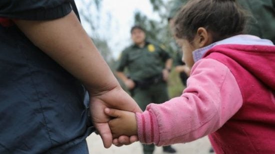 Image of a man holding a little girl's hand