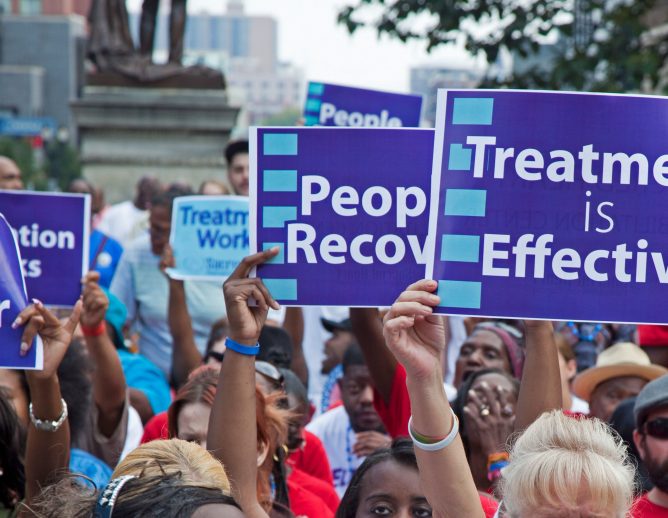 protest with sign that reads "treatment is effective"