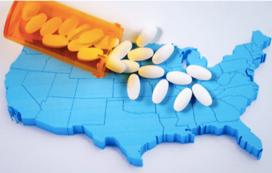 bottle of pills spilling over a map of the United States