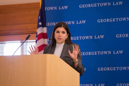 Woman speaking from a podium