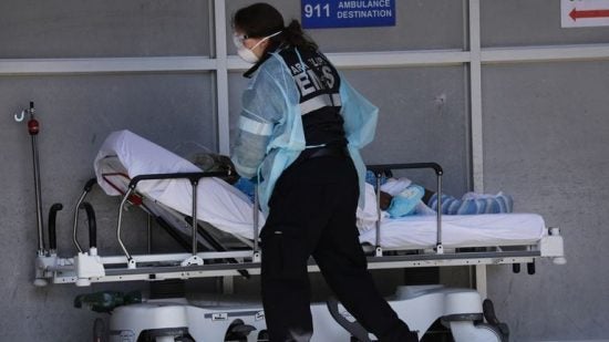 Health care worker pushing a stretcher