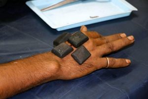 hand with black stones