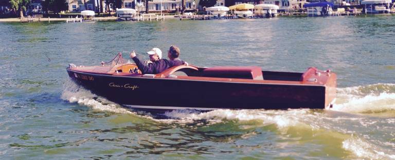 Two men driving a boat