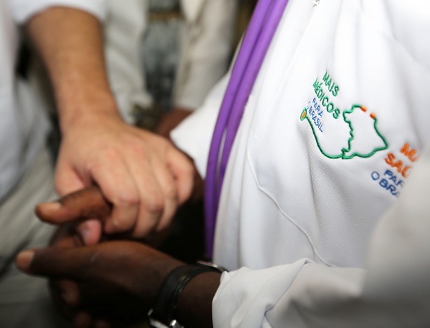 Patient holding doctors hands