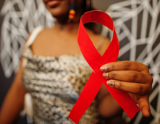 Adobe Stock image of woman holding red ribbon