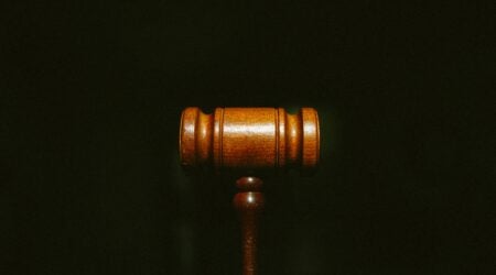 A wooden gavel on black background