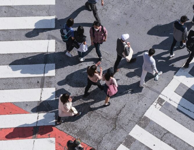 Bird's eye view of people walking across the street