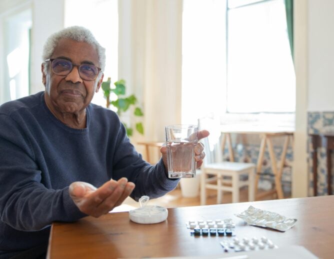 Older patient with medication at table